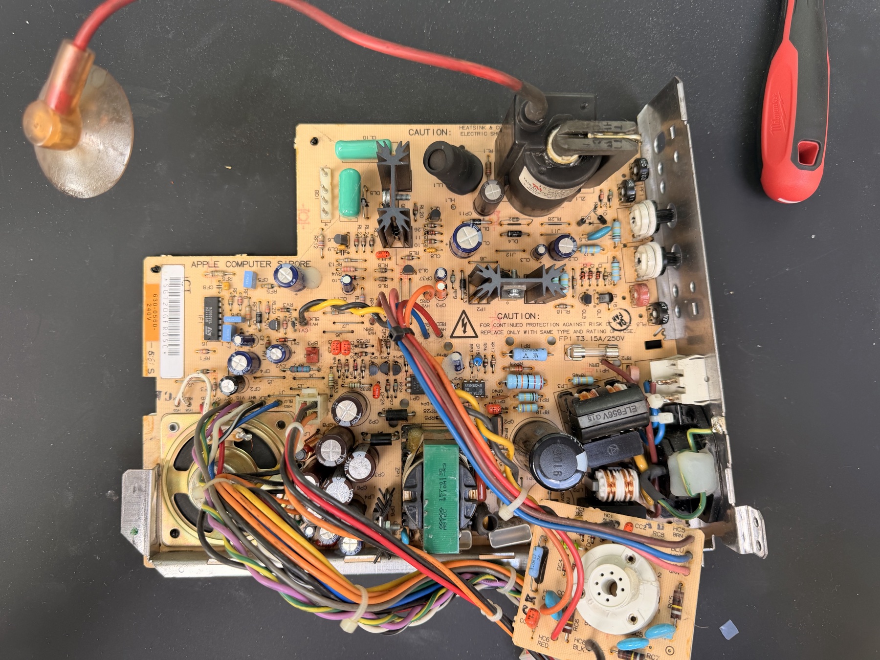 The Macintosh Classic analog board removed from the case with its wiring harnesses still attached