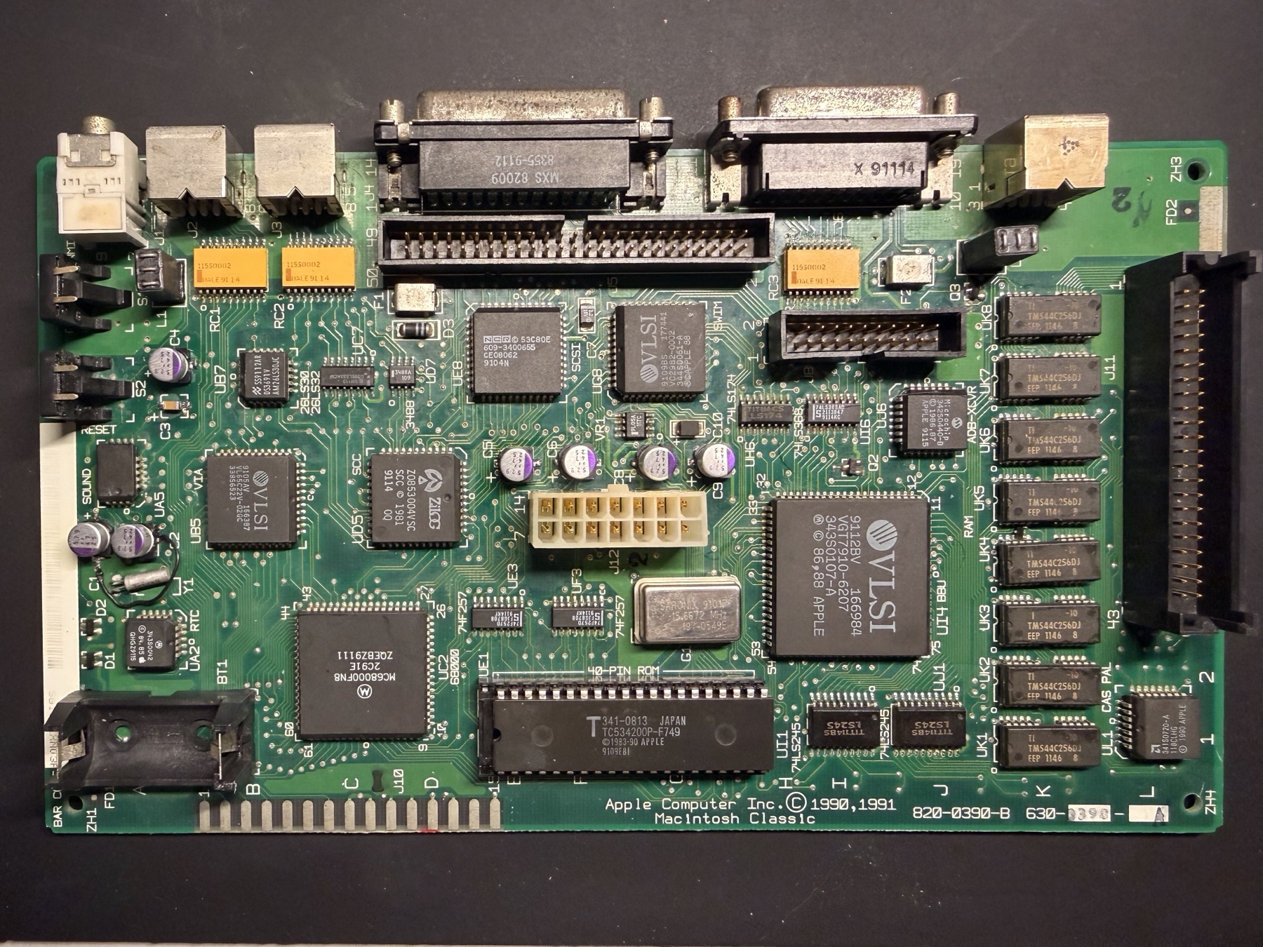 The full Macintosh Classic logic board after all planned replacement capacitors were installed